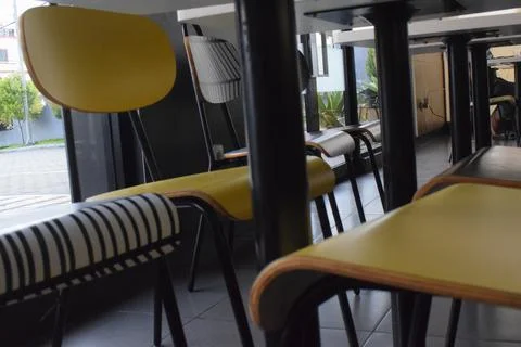 Empty yellow chairs in restaurant Stock Photos