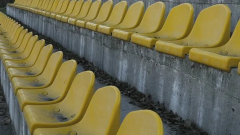 Empty yellow chairs at the stadium. Canceled match, game. A stadium without fans Stock Footage 88427980