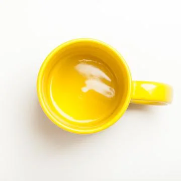 Empty yellow coffee, tea mug, cup, top view on white Foto stock