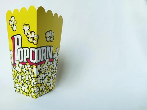 Empty yellow popcorn paper box on white background. Stock Photos