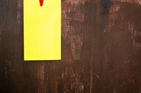 Empty yellow post its on the brown wooden wall. Stock Photos