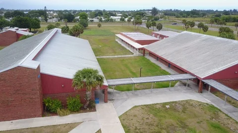 EmptyHigh School Campus Due to Coronavirus aerial interior pathways Stock Footage 128673218