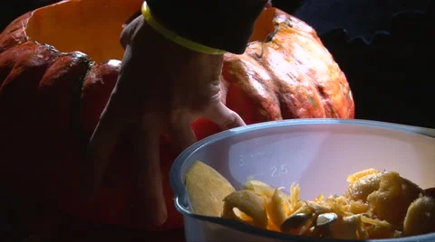 Emptying pumpkin on black scull decorated background Stock-Footage 67708638