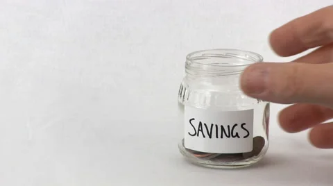 Emptying small jar of coins Stock Footage 49623567