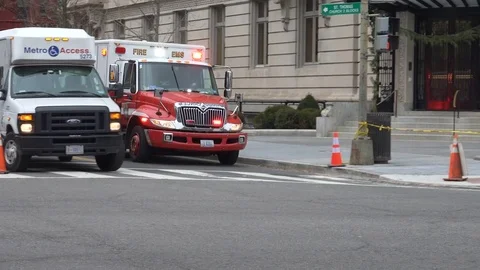 EMS Ambulance, siren, through intersection, DC, wintery Stock Footage 70631213