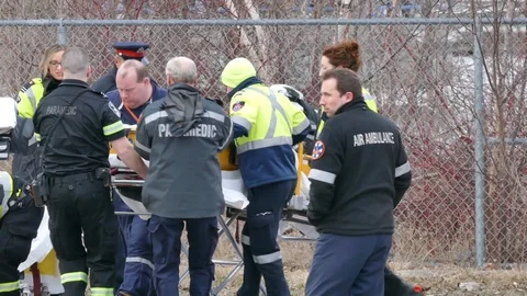 EMS doing chest compression on patient in rescue basket - 24fps 1080p Stock Footage 91567944