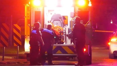 EMS joining vicitim at night Stock Footage 119950982