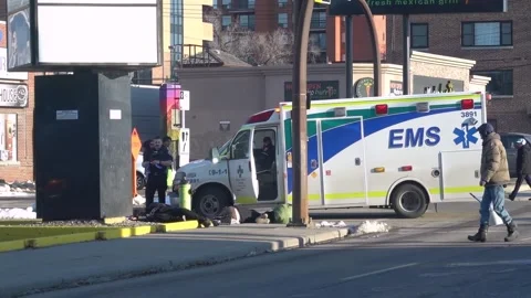 EMS paramedics treat multiple unresponsive individuals on a city sidewalk Stockbeeldmateriaal 333025055