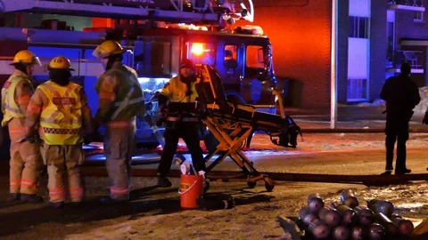 EMS passing in fire scene with stretcher Stock Footage 104299012