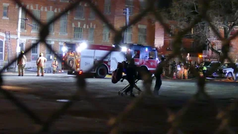EMS walking with empty stretcher at night Stock Footage 139664416