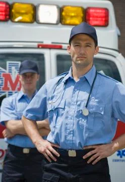 EMT?s posing in front of ambulance Stock Photos