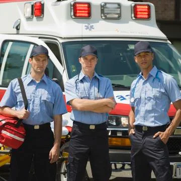 EMT?s posing in front of ambulance Stock Photos