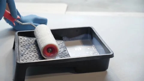 Emulsion Roller &amp; Plastic Tray. painter picks up the primer on the roller.  Stock Footage 157428924