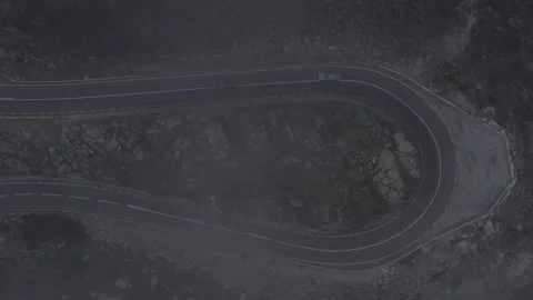 EN339 engineered hairpin bend geometry revealed through mist by top down drone Stock Footage 333465947