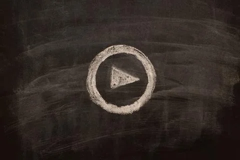 An enable button drawn on a black chalkboard in white chalk. Stock Photos