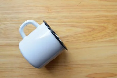 Enameled mug on a wooden surface Stock Photos