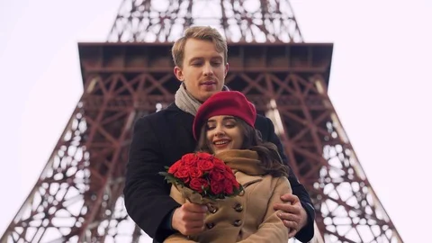 Enamored guy coming on date to his beautiful girl with huge bouquet of roses Stock Footage 83897091