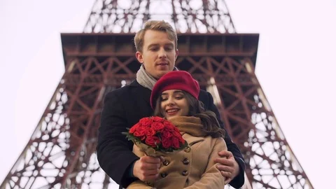 Enamored guy coming on date to his beautiful girl with huge bouquet of roses Stock Footage 83905154