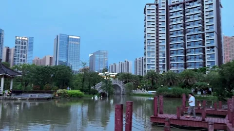 Enchanting Evening Stroll: Pano View of Chinese Park &amp; Cityscape in Guangzhou 3 Stock Footage 244018480