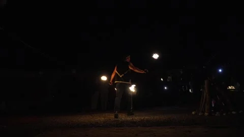 Enchanting Fire Dance Performance Under Starlit Sky in Agafay Desert Morocco Stock Footage 335888224