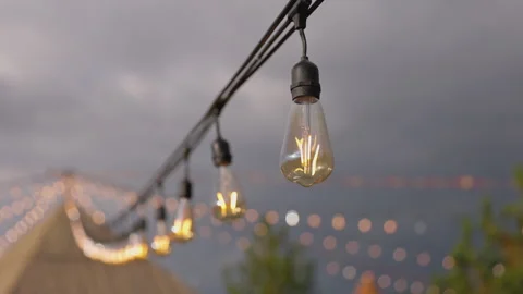 Enchanting String Lights: A Glorious Display Amidst Fluffy Clouds and Bokeh Stock Footage 318526198