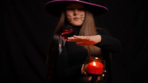 An Enchanting Witch is Casting a Spell using Candlelight in a Magical Atmosphere Stock Footage 315415030