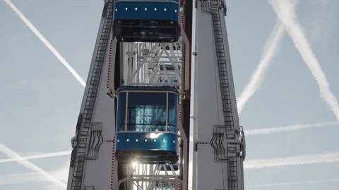Enclosed passenger cabins moving between the white structural supports Stock Footage 340333661