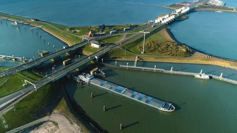 Enclosure Dam (Afsluitdijk): Cargo Ship and Bridge - Holland – 4K Drone Stock Footage 127575293