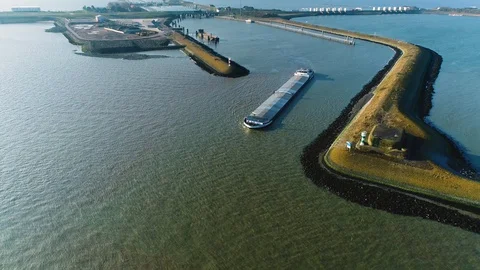 Enclosure Dam (Afsluitdijk): Cargo Ship with the Sluice - Holland – 4K Drone Stock Footage 127575705