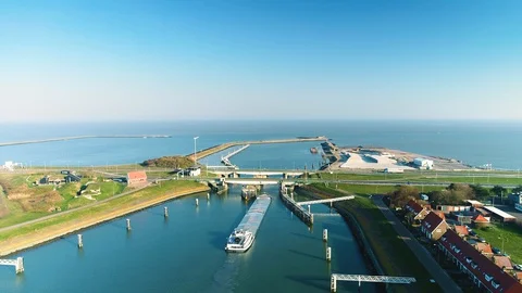 Enclosure Dam (Afsluitdijk): Cargo Ship Under Bridge - Holland – 4K Drone Video stock 127575758