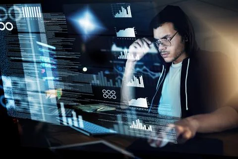 Encoding in progress. Shot of a young hacker cracking a computer code in the  Foto stock