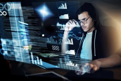 Encoding in progress. Shot of a young hacker cracking a computer code in the Foto stock
