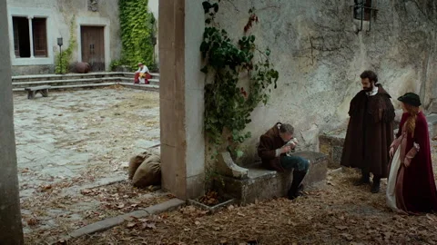 Encounter between characters in a quiet courtyard at sunset time Stock Footage 327948048