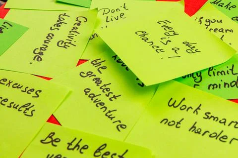 Encouraging sticky notes spread across a vibrant surface for daily motivation Stock Photos