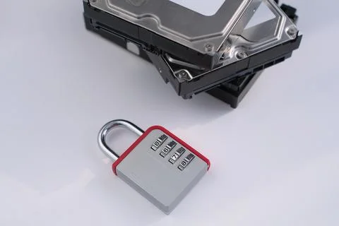 Encrypted hard disk. Padlock with cipher on an opened hard disk. Data loss 스톡 사진
