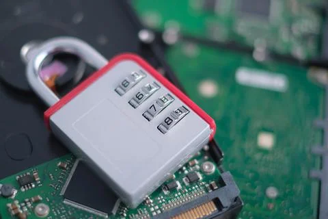 Encrypted hard disk. Padlock with cipher on an opened hard disk. Data loss Stock-Fotos