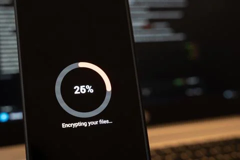 Encrypting your files progress ring at 26 percent on a dark smartphone screen 写真素材