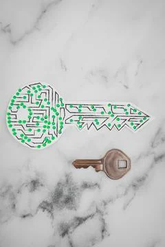 Encryption key icon made of circuits and LED lights next to old metal key Foto stock