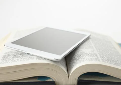 Encyclopedia and a tablet PC Stock Photos