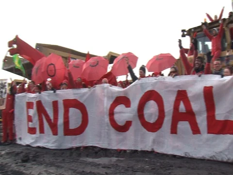 End Coal protest in Wales with banner and red dressed protesters Stock Footage