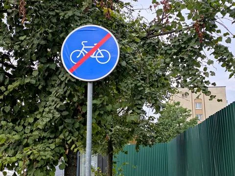 End of Cycle Path Road Sign Surrounded by Lush Green Trees Stock Photos