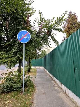 End of Cycle Path Sign Marking a Transition in Urban Landscape Stock Photos