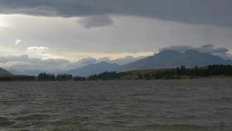 End of day light on a lake surrounded by mountains, in New Zealand Stock Footage 217370164