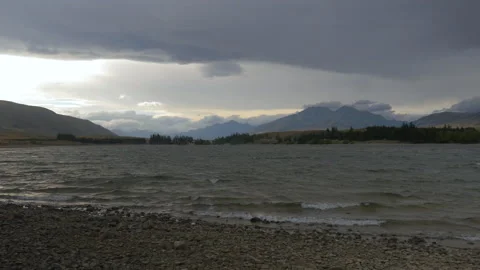 End of day light on a lake surrounded by mountains, in New Zealand Stock Footage 217374614