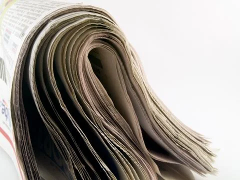 End of folded newspaper on white Stock Photos