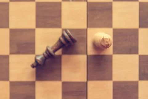 End game of chess with one fallen king figure. Stock Photos