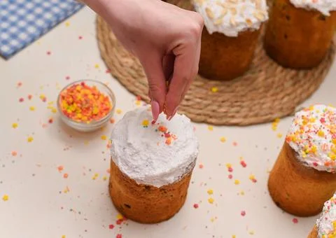 The end of the preparation of the Easter cake. The final stage is sprinklin.. Stock Photos