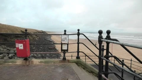 End of Promenade with dark cliff fall and distant pier 動画素材 260504030