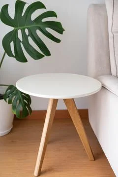 End table, round coffee table isolated near the couch Stock Photos