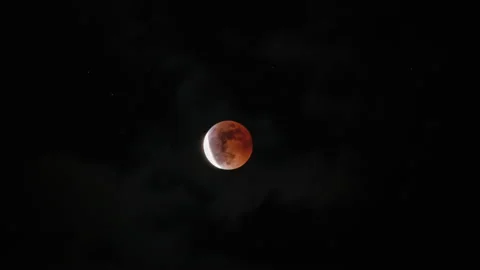 End of the Total Lunar Eclipse with Clouds Passing By Stock Footage 221288257